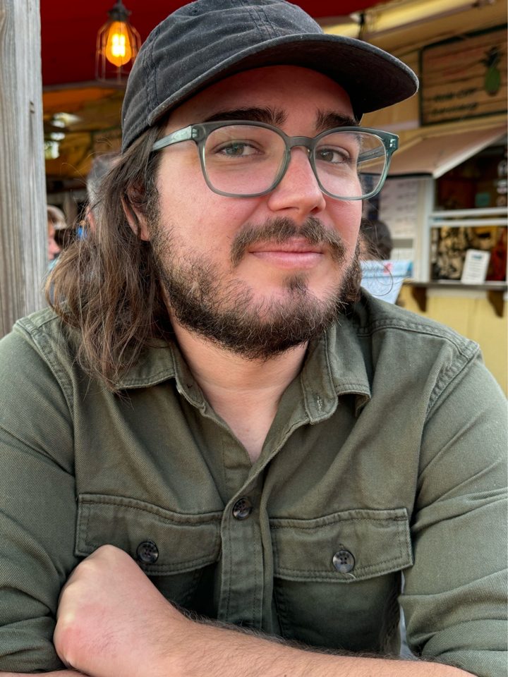 Customer photo: a man with long hair, glasses and a cap